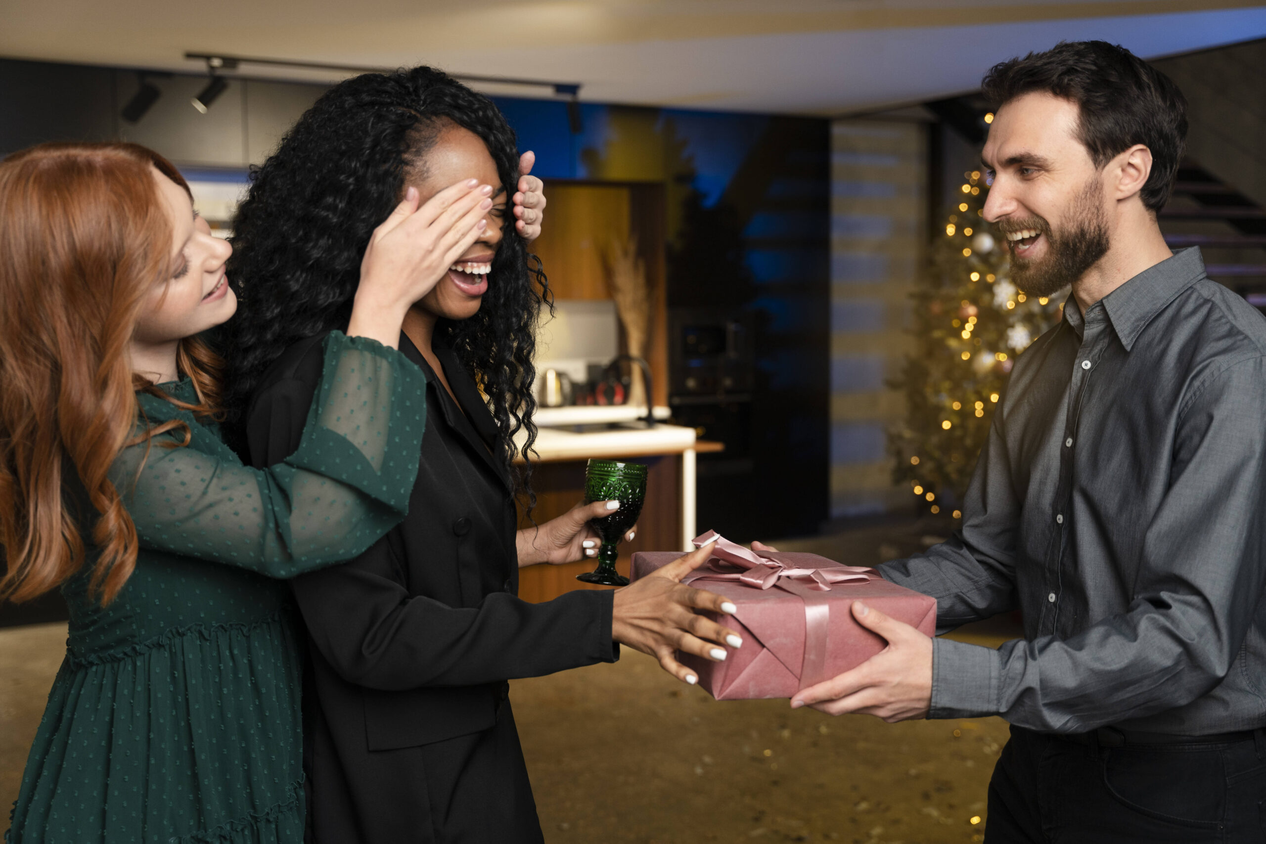 Três amigos celebrando com presente e alegria