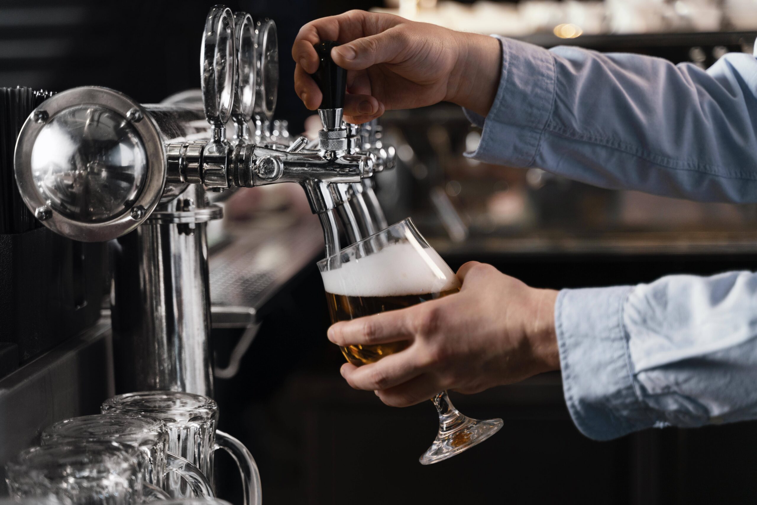 159fb405_close-up-hands-pouring-beer-glass.jpg